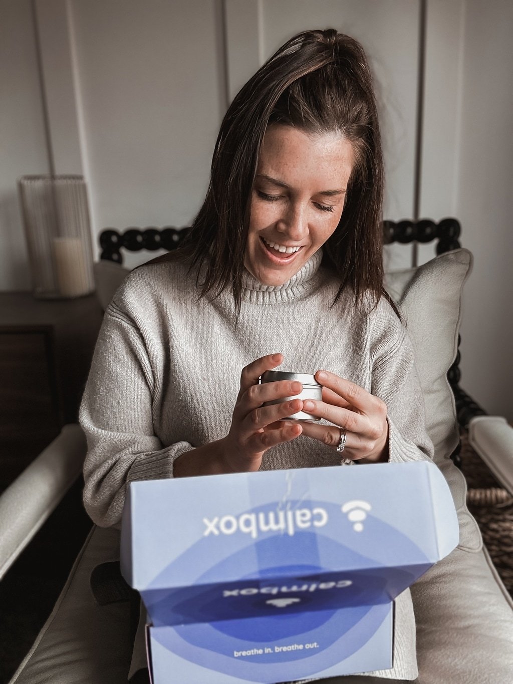 a happy woman opening a calmbox